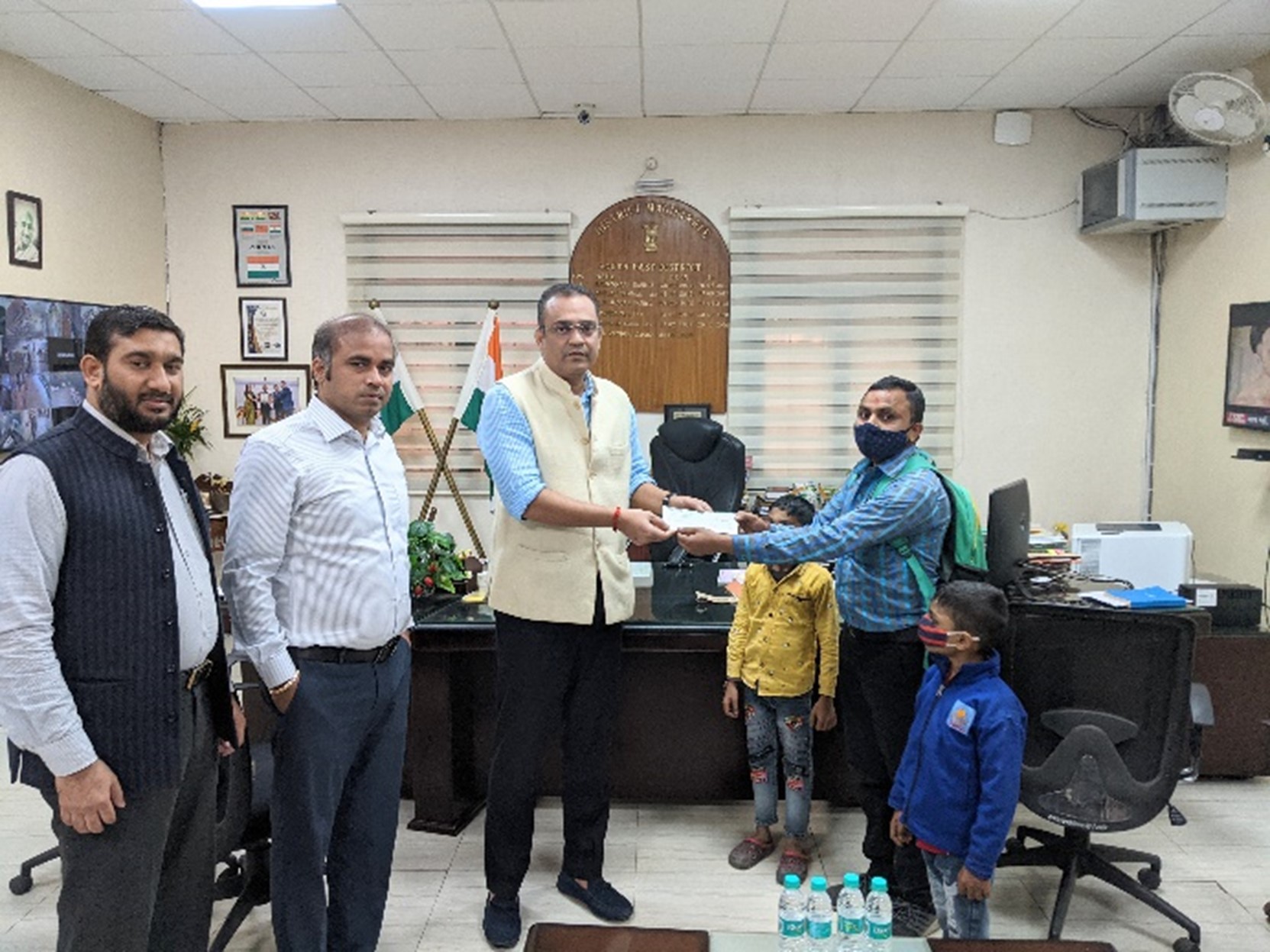 Mr. Vishwendra (D.M, South-East Delhi) hand over cheque for hearing impaired children